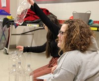 two students running steam night station