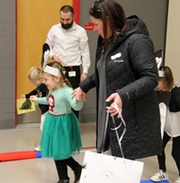 students and adults taking part in pre k family day activity