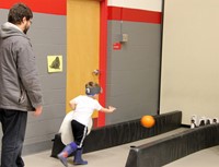 student and adult penguin bowling