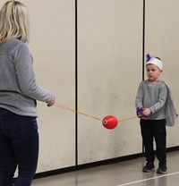 student and adult playing game