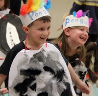two students smiling and dancing