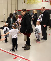 adults and students dancing