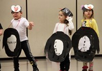 three students in penguin parade