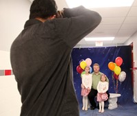 wide shot of three people getting their photo taken