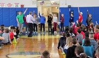 another medium shot of students raising hands to answer question