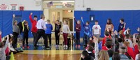 medium shot of students raising hands to answer question