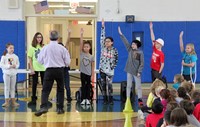 students raising hands to answer question