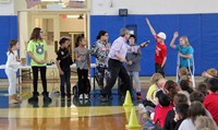 student answering question at show of love assembly