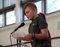 student speaking as host of poetry recitation