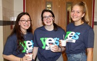 three yes leads students smiling
