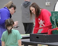 student and adult taking part in activity