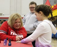 additional student getting nails painted