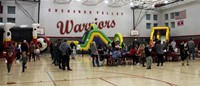 wide shot of community night in high school gymnasium