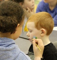 student getting face painted