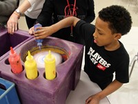 student doing spin art