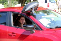 senior in parade smiling