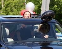 senior in parade smiling