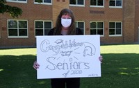 teacher holding sign at parade