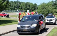 senior vehicle with balloons in parade