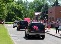 teachers waving to parade of vehicles