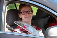 student in parade smiling