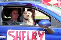 student in parade smiling