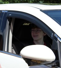 student in parade smiling