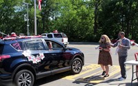 student in parade smiling