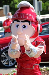 student in parade waving 