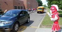 teachers waving to students at parade