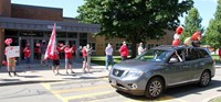 student in parade waving