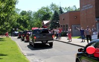 teachers waving to student in parade