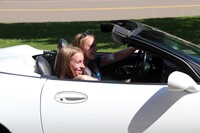 teacher waving to students in parade