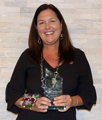 Dr. Megan Conklin Pecha holding award
