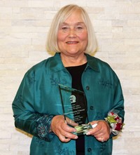 Joan Mitrowitz Tymeson holding award