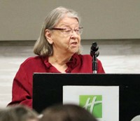 Sally Reutlinger speaking at podium