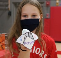 student holding fortune teller