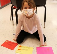 student with cards