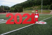 student standing next to 2021 sign