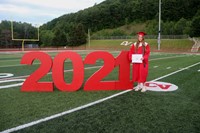 student standing next to 2021 sign