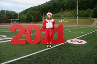 student standing next to 2021 sign