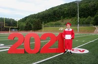 student standing next to 2021 sign