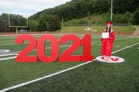 student standing next to 2021 sign