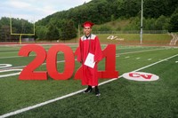 student standing next to 2021 sign