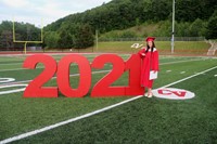 student standing next to 2021 sign