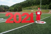 student standing next to 2021 sign