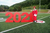 student standing next to 2021 sign