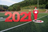 student standing next to 2021 sign