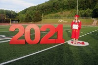 student standing next to 2021 sign