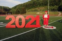 student standing next to 2021 sign